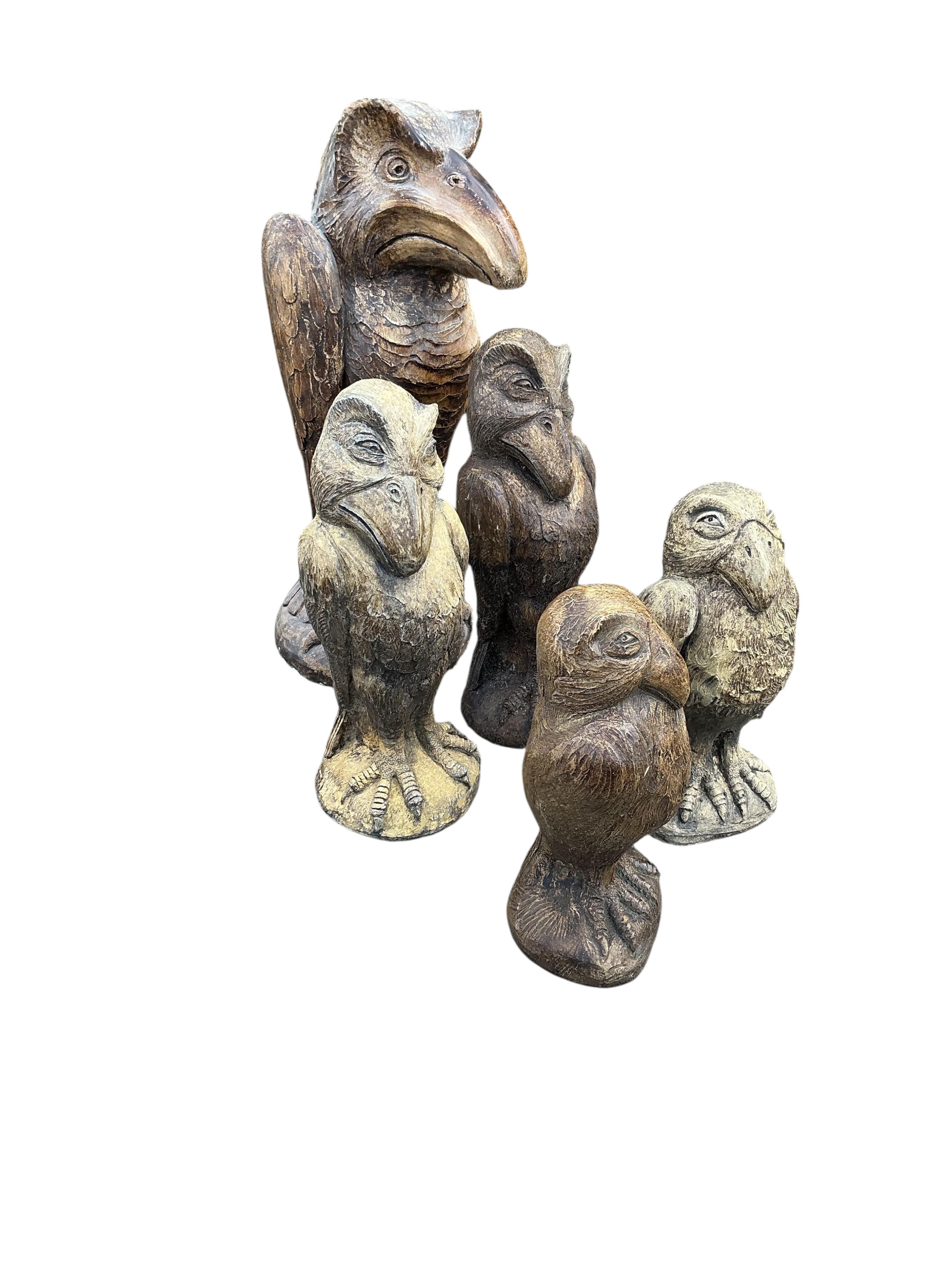 Five cast stone 'Wally' bird ornaments in the style of Martin Bros., largest height 48cm